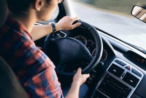 man sitting in driver's seat