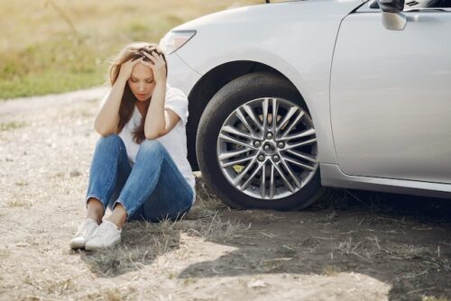 girl sitting by car