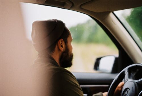 man driving car