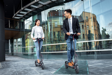 man and woman on electric scooters