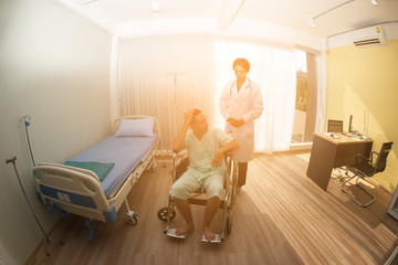 man in wheelchair in hospital room