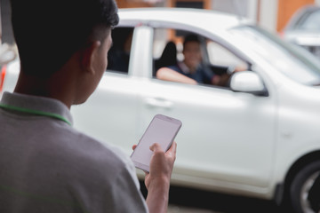 person with uber app open and car in front of them
