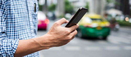 man ordering uber on phone