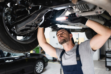 auto mechanic working on car